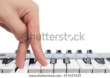 fingers walking on piano keys isolated on white. concept = start playing & keep walking to destination of music life
