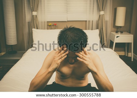 unhappy, insomnia & worried asian handsome man thinking about his problem on white bed in bedroom all night