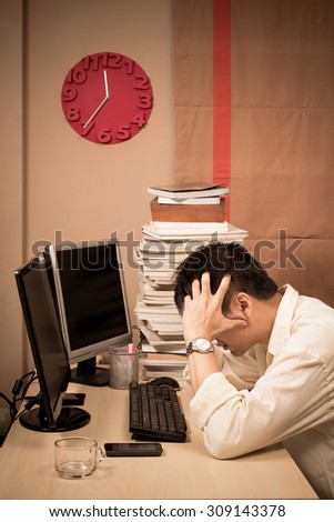 Tired & headache asian businessman work overtime