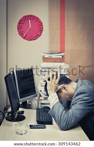 Tired & headache asian businessman work overtime
