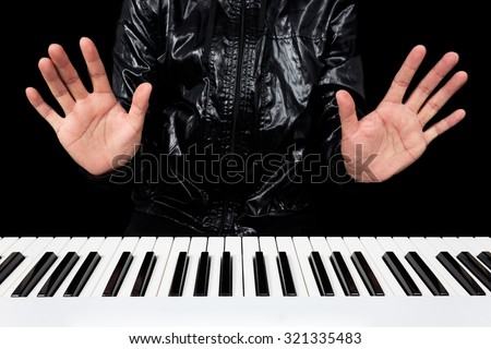hands of male pianist / musician playing piano isolated on black for music concept