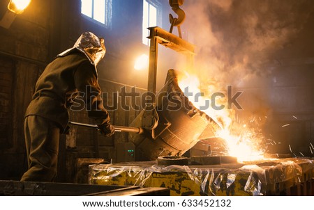 Worker controlling metal melting in furnaces. Workers operates at the metallurgical plant. The liquid metal is poured into molds. 商業照片 © 