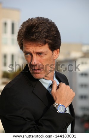 Portrait of an attractive business man with watch