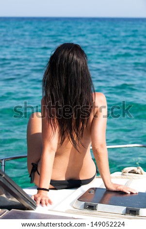 Woman on a boat looks to the sea
