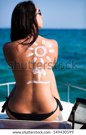 Woman with sunscreen on the boat