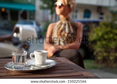 Pretty woman alone in a street cafe