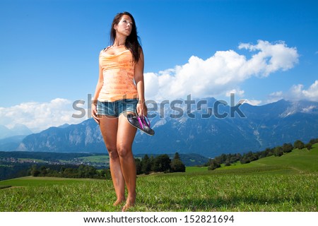 Slender woman in hot pants in the mountains