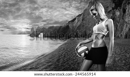 Beautiful girl with a volley ball on a beach at sunset