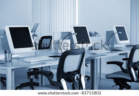 Computers with LCD screens in modern office in the blue tilt
