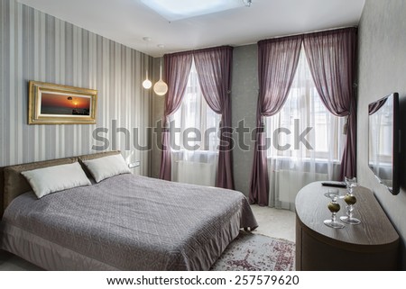 Modern master bedroom interior with picture of sunset on the wall (photo coming from my gallery)