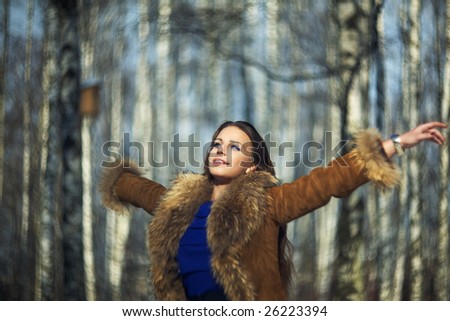 fashion beautiful woman in the winter forest