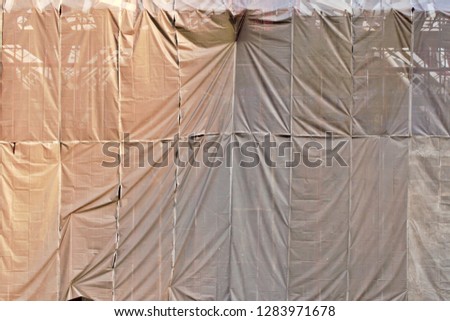 Similar – Image, Stock Photo Scaffolding with protective net and tarpaulin from frog perspective / house renovation