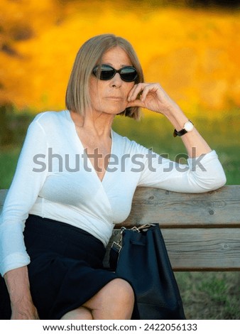 Similar – Image, Stock Photo fit senior lady dressed in black by the lake