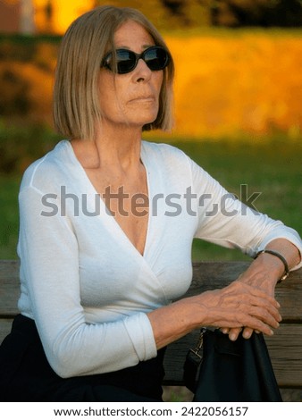 Similar – Image, Stock Photo fit senior lady dressed in black by the lake