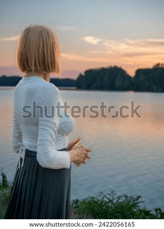 Similar – Image, Stock Photo fit senior lady dressed in black by the lake