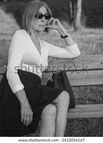 Similar – Image, Stock Photo fit senior lady dressed in black by the lake