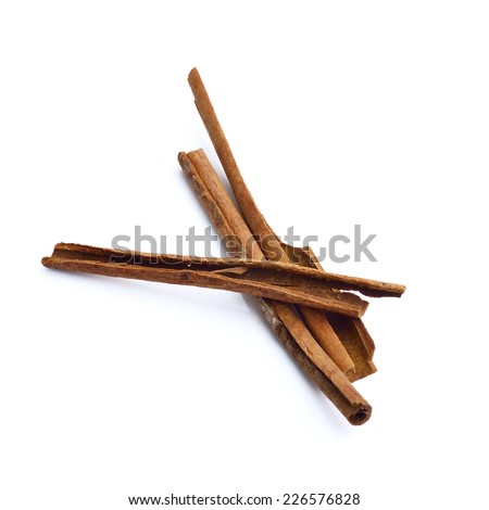 heap of cinnamon sticks isolated on white background, christmas spices