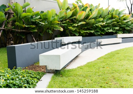 White concrete bench in a garden