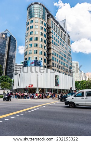 SINGAPORE - JUNE 20: Pedestrians walk along famous Orchard road on JUNE 20, 2014 in Singapore. This 2.2 kilometer street is the retail and entertainment hub of Singapore and major tourist attraction.