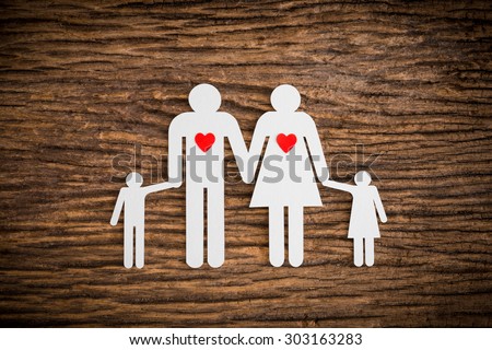 paper chain family and red heart symbolizing on wooden background. love family concept