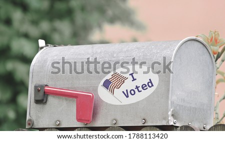 Metal mailbox for rural homes with I Voted sticker as concept for voting by mail or absentee ballot paper