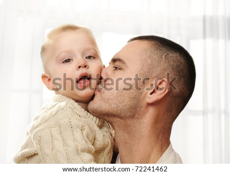 Happy daddy kissing the little son