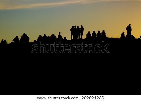 Traena, Norway-July 11 2014: people watching the concert of the Swedish pop-techno band Den svenska bjornstammen from the top of the hill at the Traenafestival, music festival held on Traena island