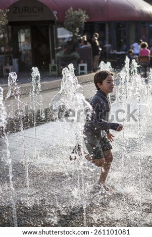 Amsterdam, The Netherlands, 13 September 2014, at West\'ival, a free open air Cinema and culture festival on Mercatorplein, child having fun in the fountain