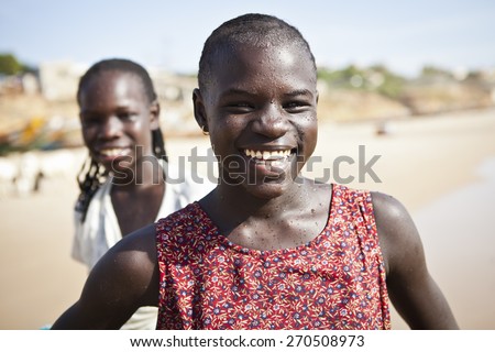 SENEGAL, Ndayane - November 9, 2013: Senegalese children on the beach of Ndayane, playing and waiting for their father to come back from fishing. Despite poverty, Senegal kids stay smiling.