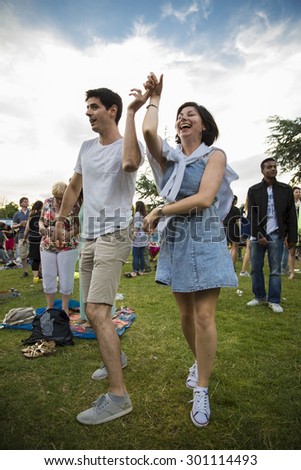 Amsterdam, The Netherlands - July, 5 2015: people dancing salsa during the concert of Colombian band LA-33 at Amsterdam Roots Open Air, cultural festival held in Park Frankendael on 05/07/2015