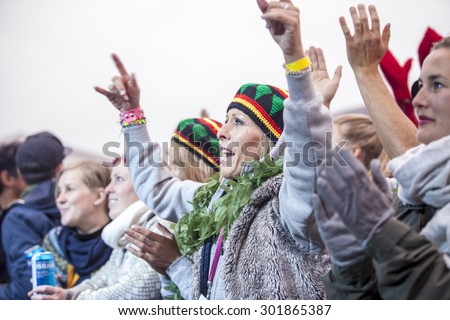 Traena, Norway - July 10 2015: ladies arms up in the air at concert of Norwegian band Kim Lie og hans Langt Nord Band at the Traenafestival, music festival taking place on the small island of Traena