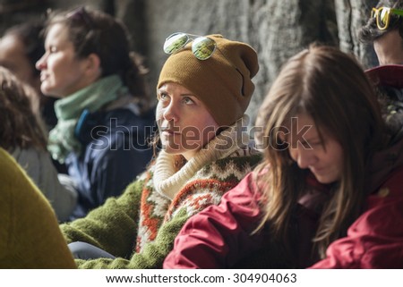 Traena, Norway - July 11 2015: audience at concert of Norwegian singer Anneli Drecker in Kirkehelleren cathedral cave on Sanna Island, at Traenafestival, music festival.