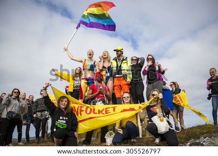 Traena, Norway - July 11 2015: group of colorful people participating in the smallest gay Pride in Europe during Traenafestival, music festival taking place on the small island of Traena.