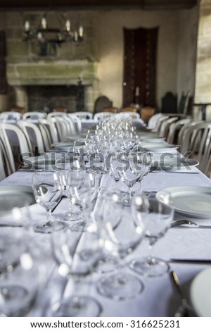 Table set for an event party or wedding reception in a old medieval castle room