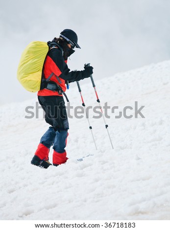 Man rising on the slope with poles