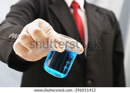 business man holding chemistry science beaker