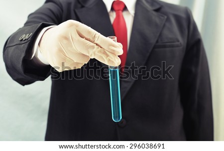business man holding chemistry test tube at science lab