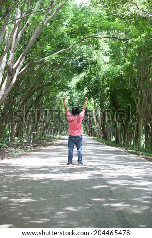 Man in the middle of the street trees