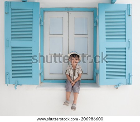 Boys 3-4 years old, sitting Window, be happy, Asia, Thailand.