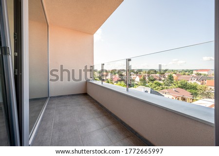 Similar – Image, Stock Photo An empty balcony and a closed shutter above it, plus a railing that no longer protects anyone