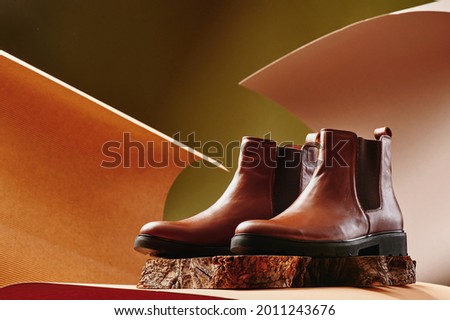 Brown leather chelsea boots made of genuine leather in classic style on a wooden cut. Close-up ストックフォト © 