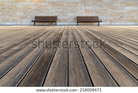 Outdoor timber chairs on timber floor and sand stone wall