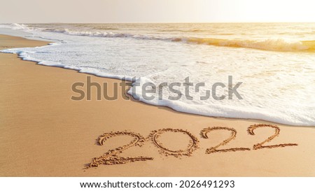 2022 happy New Year coming concept. White waves are lapping towards the shore