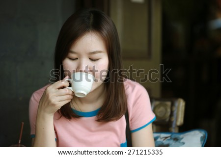 Asia women drinking coffee in cafe shop on free day, Relax time on cafe shop, Beautiful Girl Drinking Tea or Coffee in Cafe