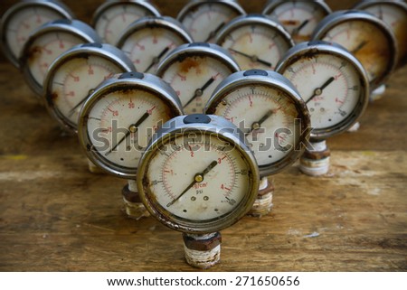 Old pressure gauge or damage pressure gauge of oil and gas industry on wooden background, Equipment of production process.