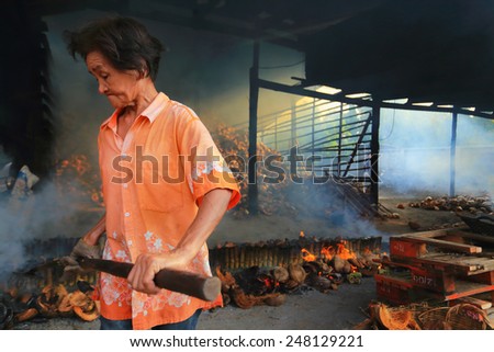 THAILAND-NOVEMBER 30: an unidentified woman work in glutinous rice roasted in bamboo joint factory on November 30, 2014 in Thailand