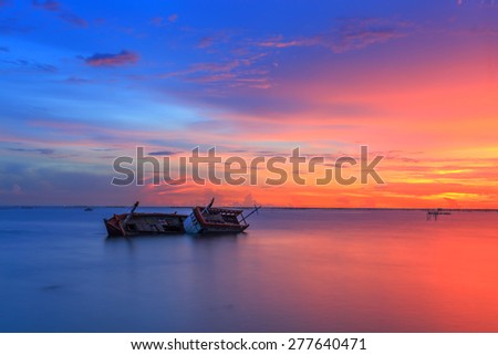sinking boat and twilight sky