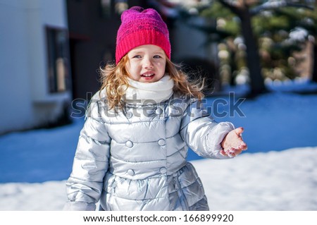 Cute baby girl enjoying first snow