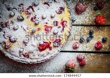 Berry tart on wooden table