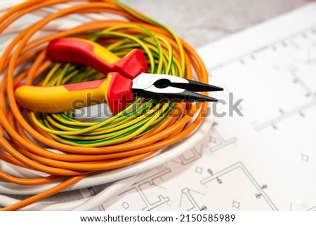 Electrician's tool and cable hank on the house electrification plan Stock fotó © 
